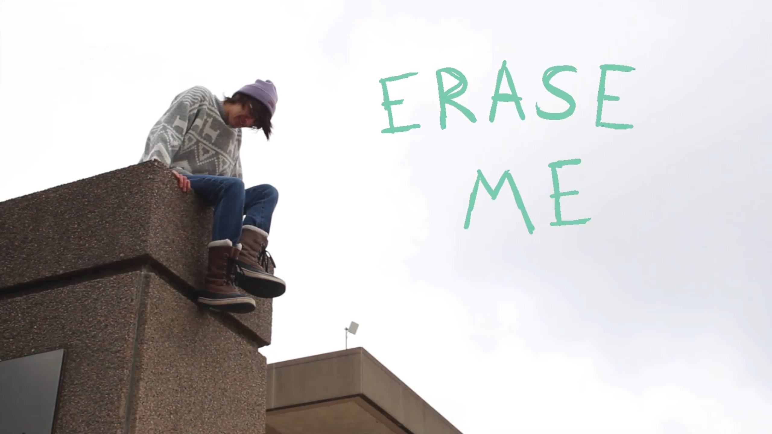 actor on a high ledge with text erase me